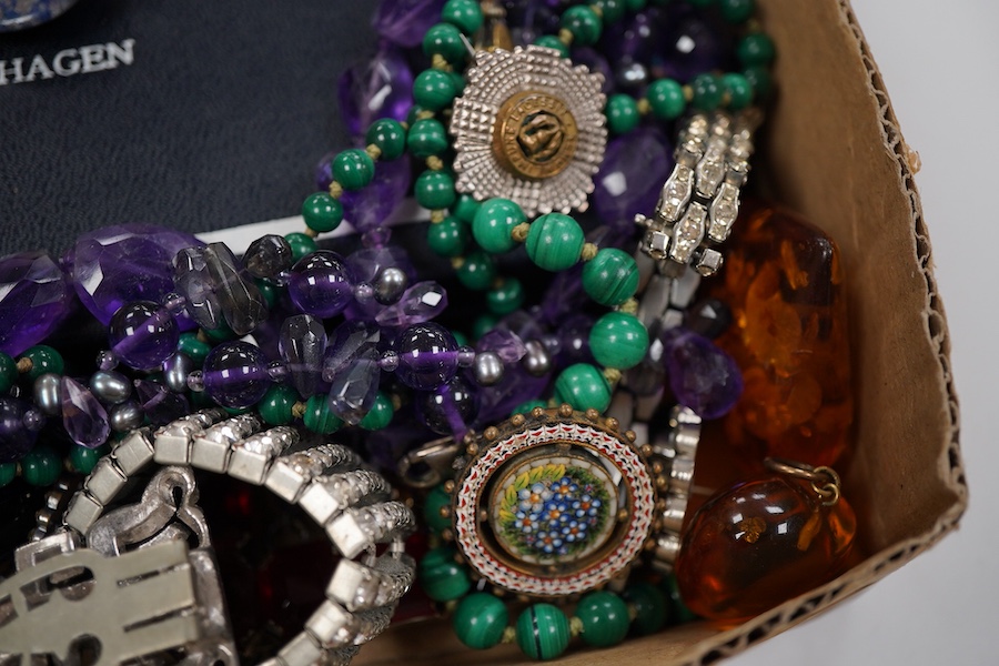 A collection of costume jewellery to include a yellow metal and amethyst ring, two George V silver and guilloche enamel brooches, two amethyst necklaces, etc